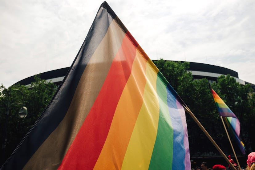 A rainbow pride flag with black and brown stripes, representing black and brown folks' inclusion in ...