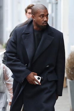 Kanye West wears a fall-appropriate coat while leaving Michiko Sushino restaurant with his daughter ...