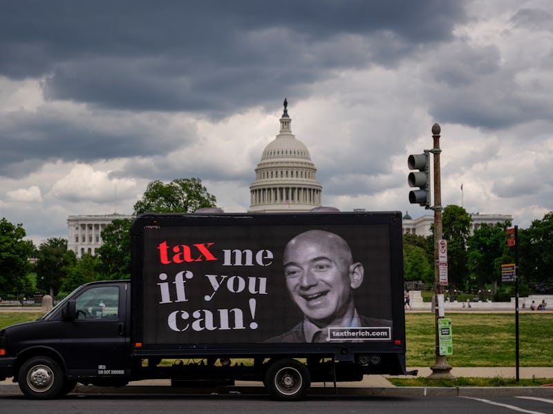 WASHINGTON, DC - MAY 17: A mobile billboard calling for higher taxes on the ultra-wealthy depicts an...
