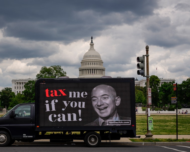 WASHINGTON, DC - MAY 17: A mobile billboard calling for higher taxes on the ultra-wealthy depicts an...
