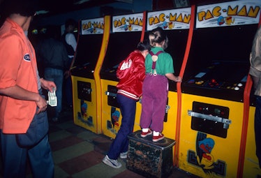 Young girls are photographed June 1, 1982 playing Pac-Man at a video arcade in Times Square, New Yor...