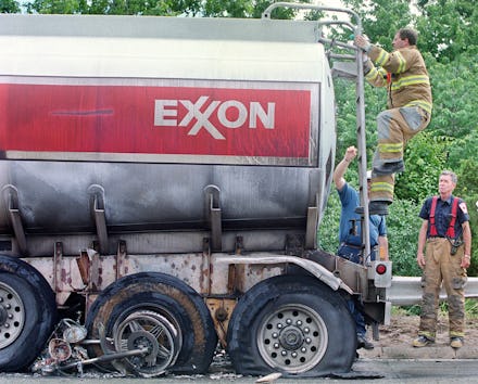 Wilmington fire fighters inspect the Exxon tanker that was involved in an accident with a motorcycle...