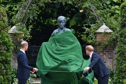Prince William, Duke of Cambridge (L) and Prince Harry, Duke of Sussex unveil a statue of their moth...