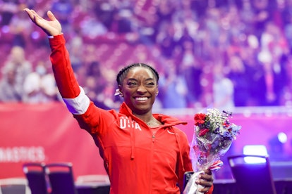 Simone Biles, who will compete at the 2021 Olympics, waves to the crowd as she exits following the W...
