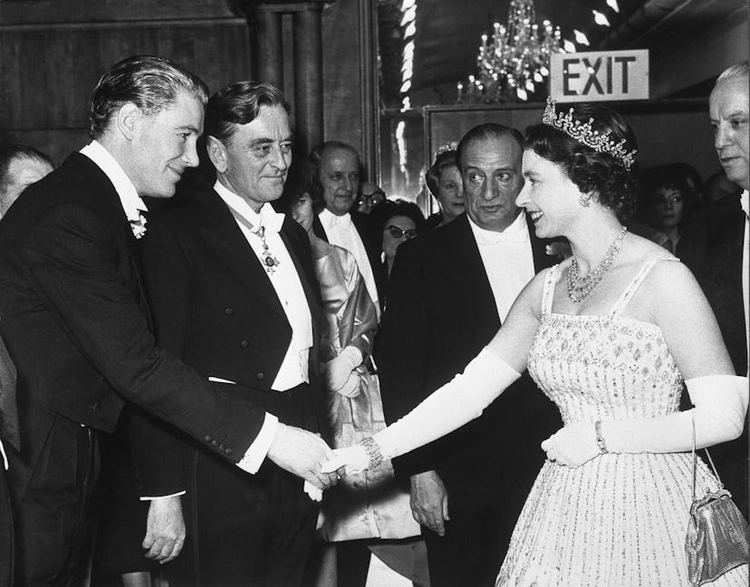 Actor Peter O'Toole shakes hands with Queen Elizabeth II at the 'Lawrence of Arabia' film premiere a...