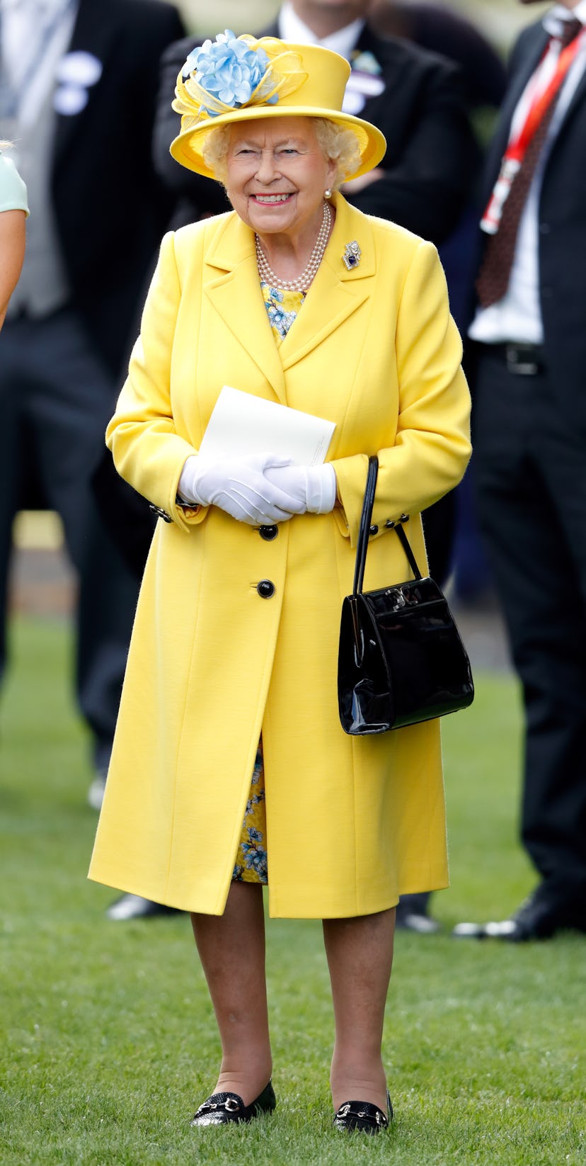 Queen Elizabeth II watches her horse 'Fabricate' run in the Wolferton Stakes on day 1 of Royal Ascot...