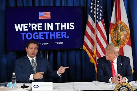 US President Donald Trump (R) and Florida's governor Ron DeSantis hold a COVID-19 and storm prepared...