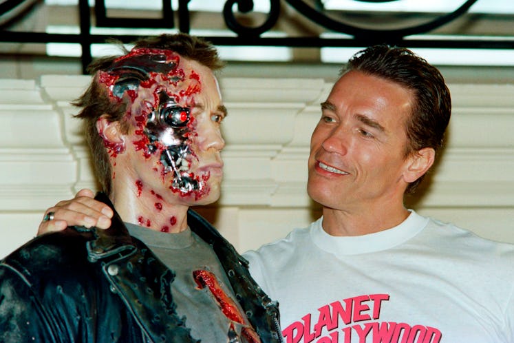 Us Actor Arnold Schwarzenegger poses next to the wax work of his new shape in the movie "Terminator ...