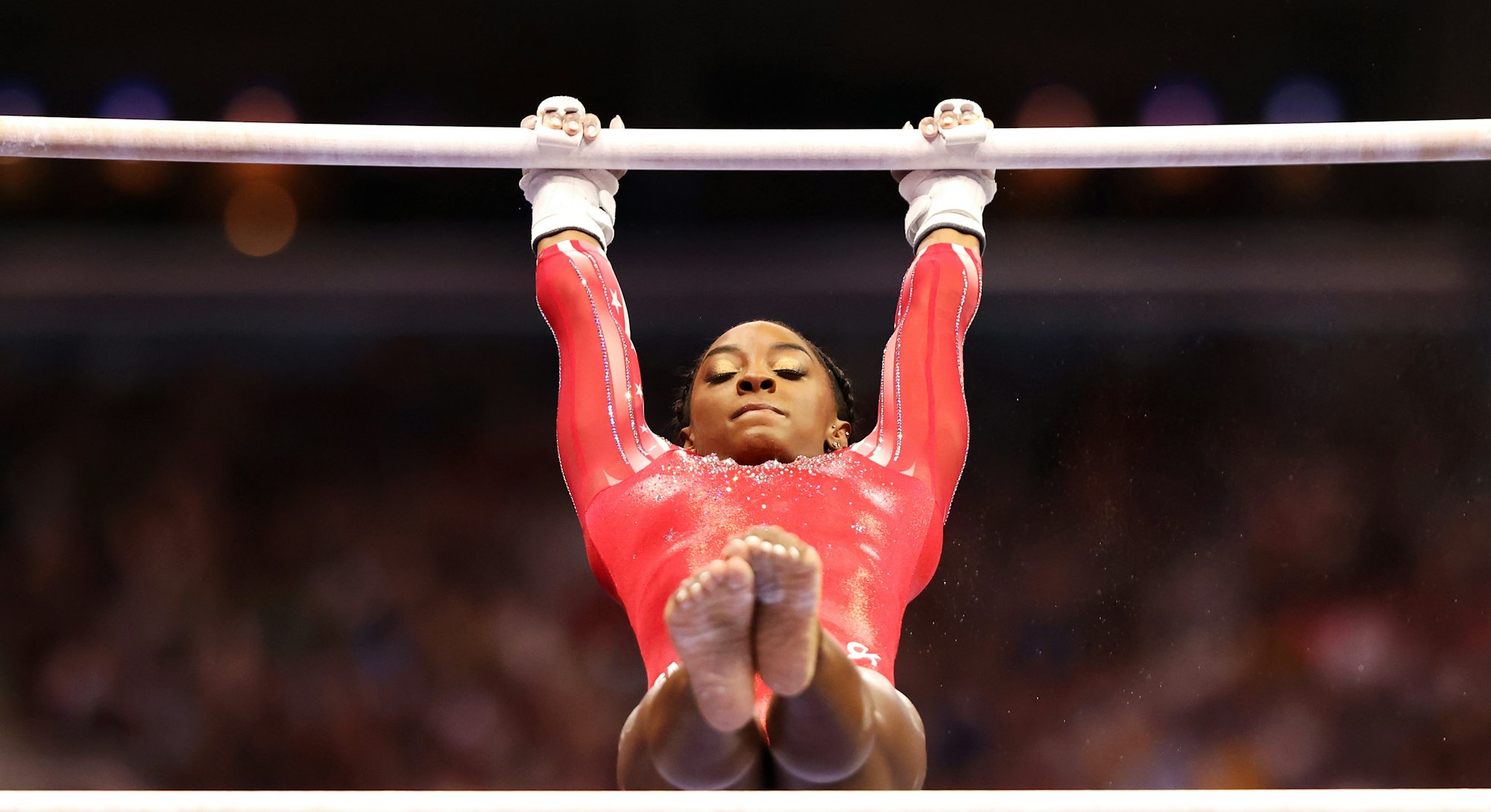 ST LOUIS, MISSOURI - JUNE 27: Simone Biles competes on the uneven bars during the Women's competitio...