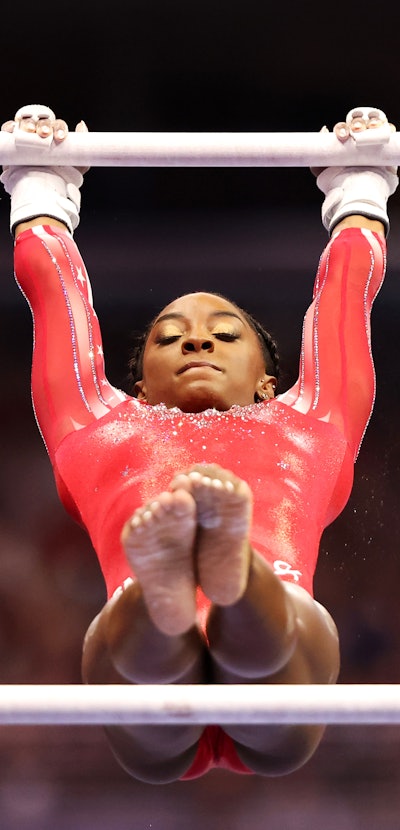 ST LOUIS, MISSOURI - JUNE 27: Simone Biles competes on the uneven bars during the Women's competitio...