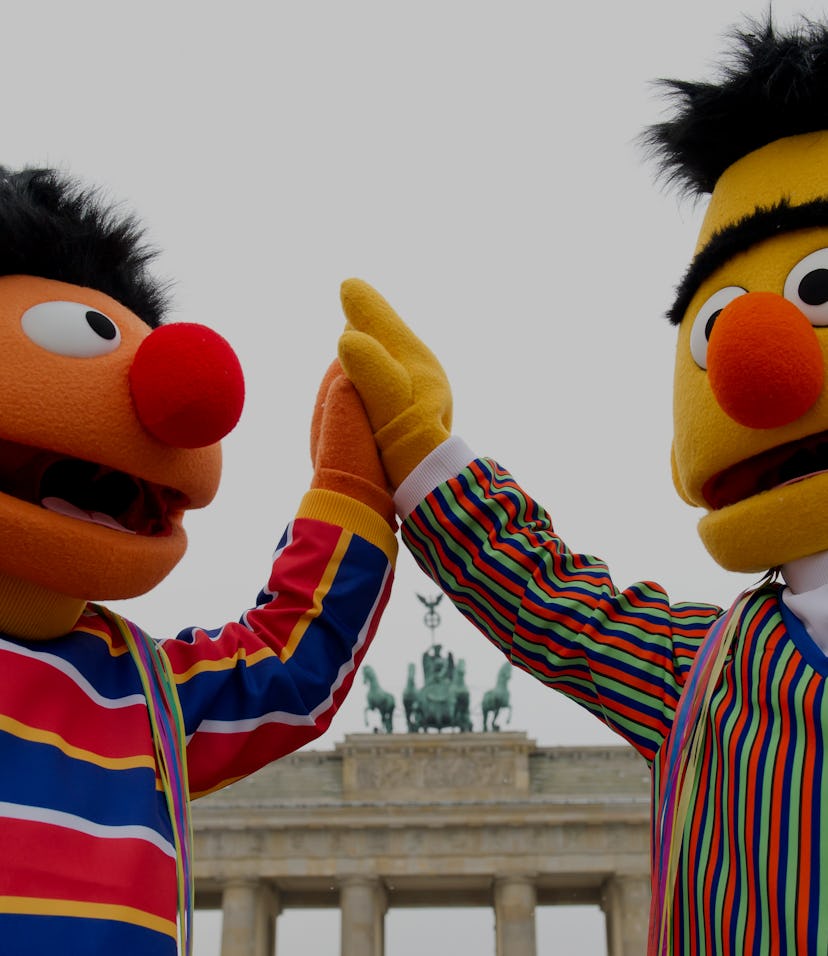 Two people dressed as Sesame Street's Ernie (L) and Bert stand in front of Brandenburg Gate in Berli...