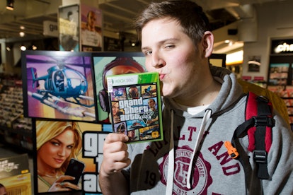 Taylor Pelling of Sutton poses with his copy of the console game Grand Theft Auto 5 at the midnight ...