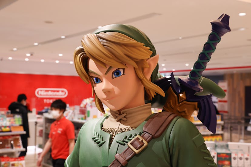 TOKYO, JAPAN - 2021/03/03: Link figurine from Legend of Zelda with shop staff inside Nintendo Tokyo ...