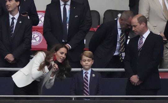 Britain's Catherine (L), Duchess of Cambridge, talks with Prince George of Cambridge (C), as Britain...