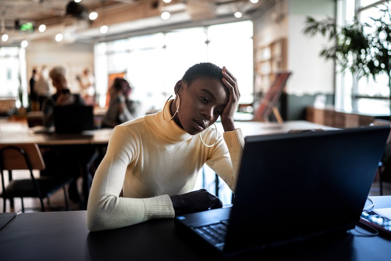 Worried businesswoman looking at laptop