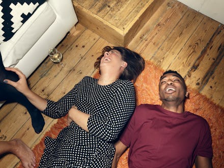 young people at a party, lying on the floor, having a good time
