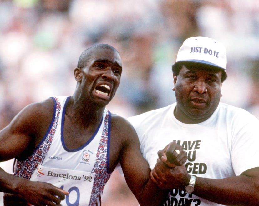 Great Britain's Derek Redmond limps to the finish line, helped by his dad Jim, after tearing his ham...