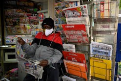 A newsagent reads the local newspaper "La Provence" in Marseille, as French newspaper distributor co...