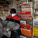 A newsagent reads the local newspaper "La Provence" in Marseille, as French newspaper distributor co...