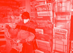 A newsagent reads the local newspaper "La Provence" in Marseille, as French newspaper distributor co...