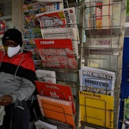 A newsagent reads the local newspaper "La Provence" in Marseille, as French newspaper distributor co...