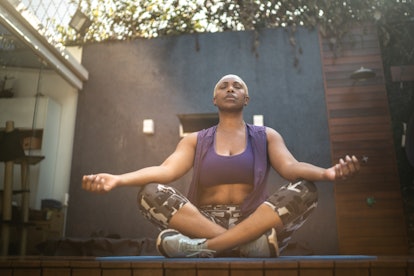 Woman meditating in the backyard with breathwork exercises