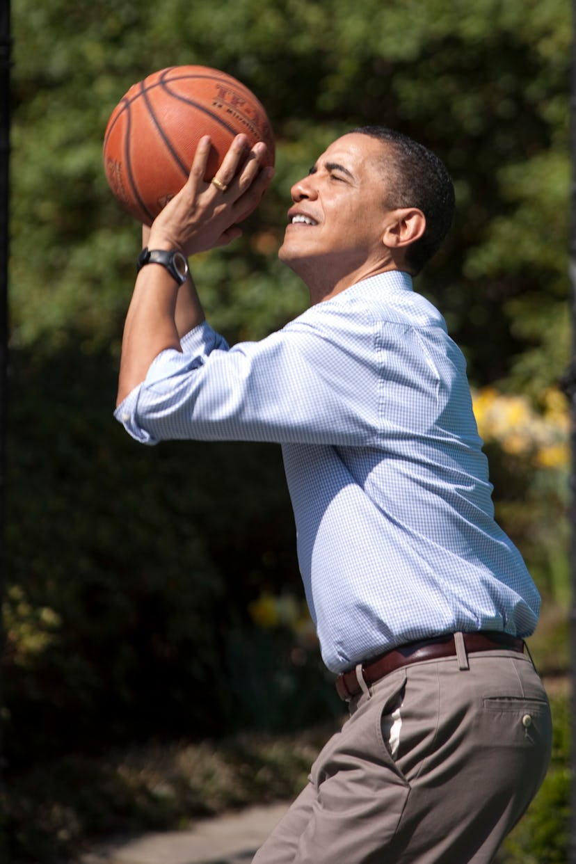 U.S. President Barack Obama shoots for the hoop as he plays basketball with children during the 2010...