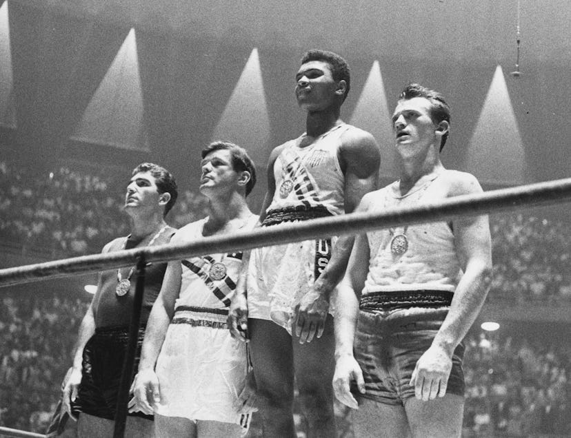 The winners of the 1960 Olympic medals for light heavyweight boxing on the winners' podium at Rome: ...