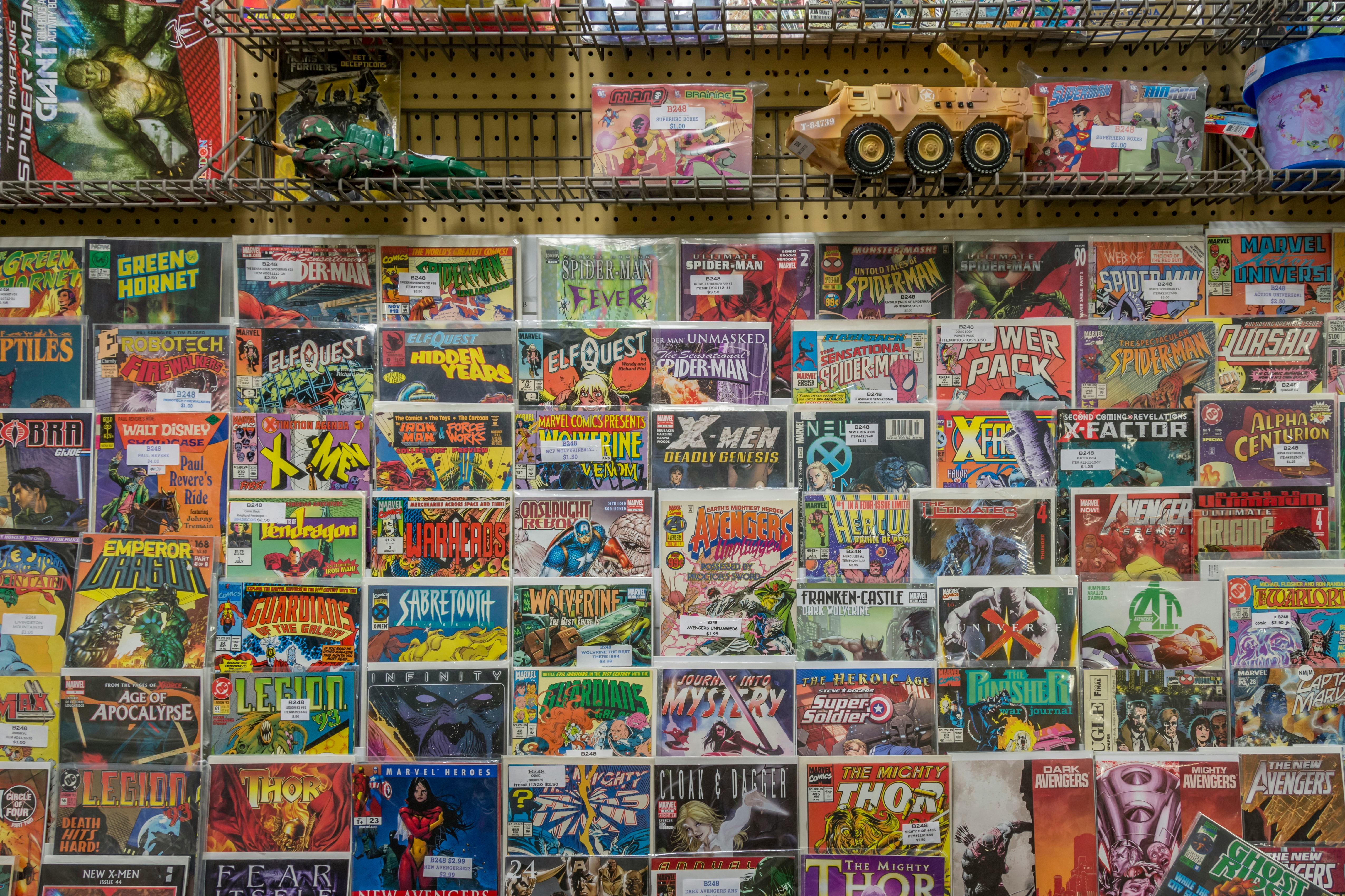 Rack of comic books and toys for sale at a flea market. (Photo by: Education Images/Universal Images...
