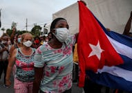 Cubans take part in a demonstration in support of Cuban President Miguel Diaz-Canel's government in ...