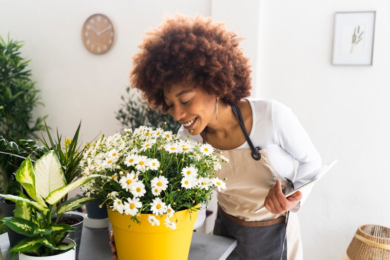 woman happy smelling flowers