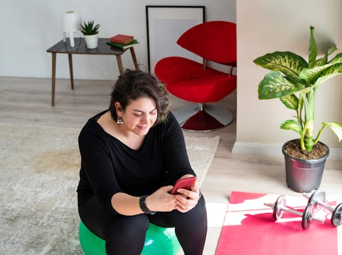 A person sits on an exercise ball while texting a friend. Reaching out to your friend when they're d...