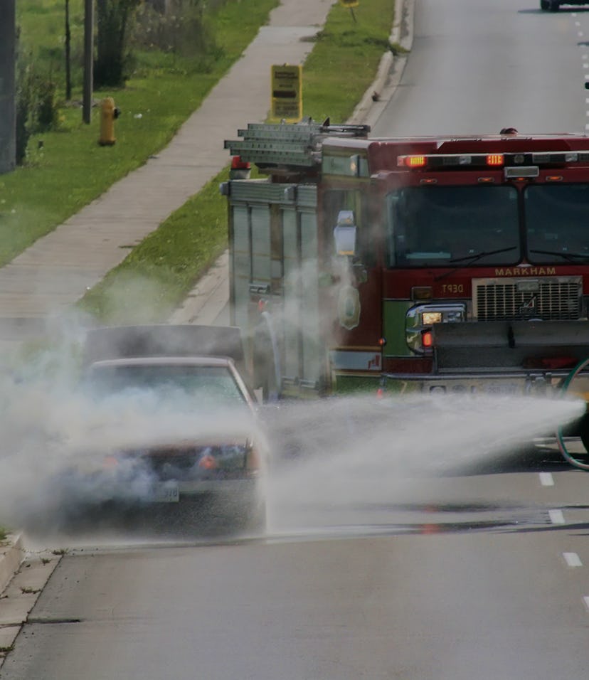 Firemen extinguish an engine fire of an overheated vehicle in Markham, Ontario, Canada, on October 1...