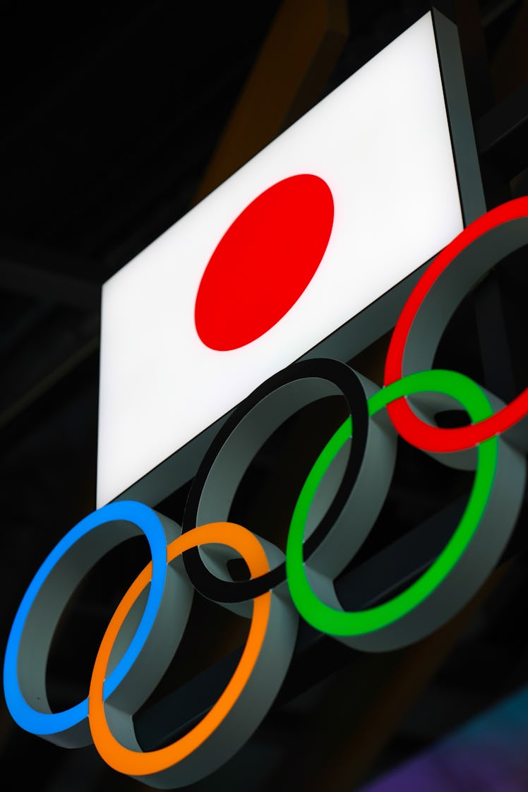 TOKYO, JAPAN - 2021/03/15: Japanese flag with Olympic Rings above the entrance to the Japan Olympic...