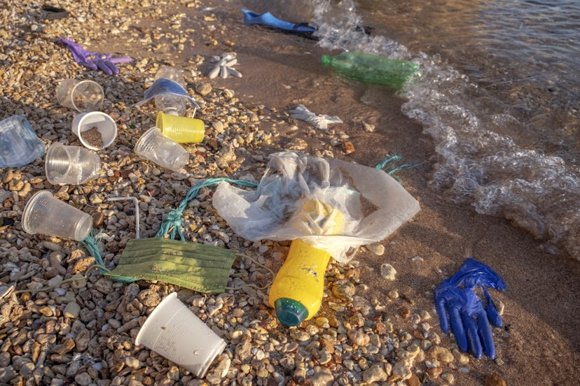 RED SEA, SHARM EL SHEIKH, EGYPT - OCTOBER 2020: Plastic debris and face masks on the beach in surf z...
