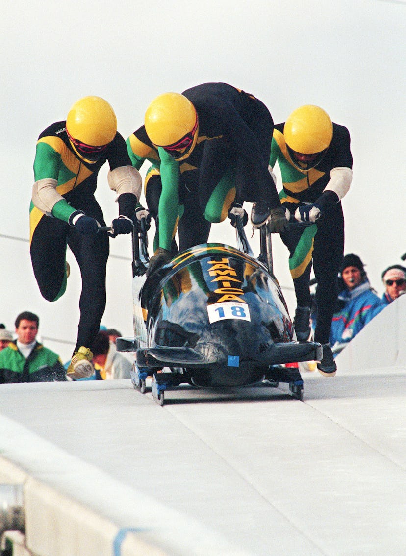 Jamaican four-man bobsleigh pilot Dudley Stokes jumps in as his three teammates push off at the star...