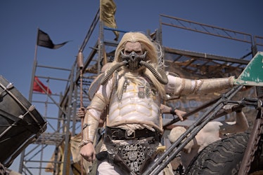 A man in a "Mad Max" Immortan Joe costume poses for pictures during Wasteland Weekend festival at th...