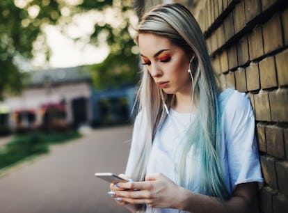 20 year old hipster woman dressed in street style clothing living typical London urban lifestyle. Wo...