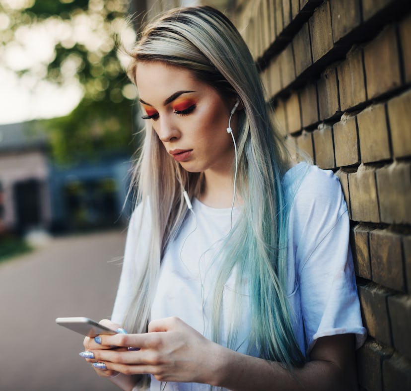 20 year old hipster woman dressed in street style clothing living typical London urban lifestyle. Wo...