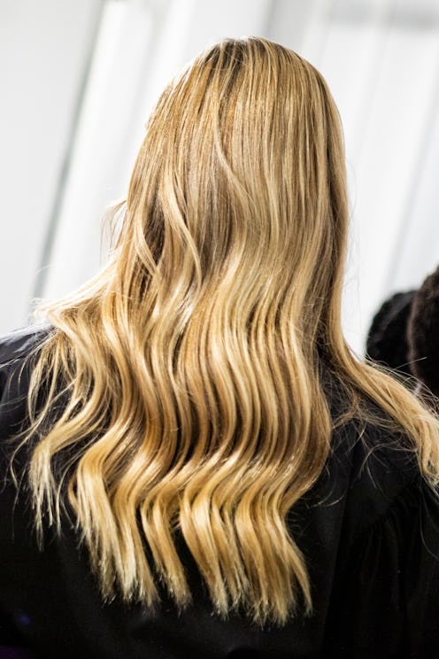 MILAN, ITALY - SEPTEMBER 27: A model, hair detail, is seen backstage at the Shi.Rt fashion show dur...