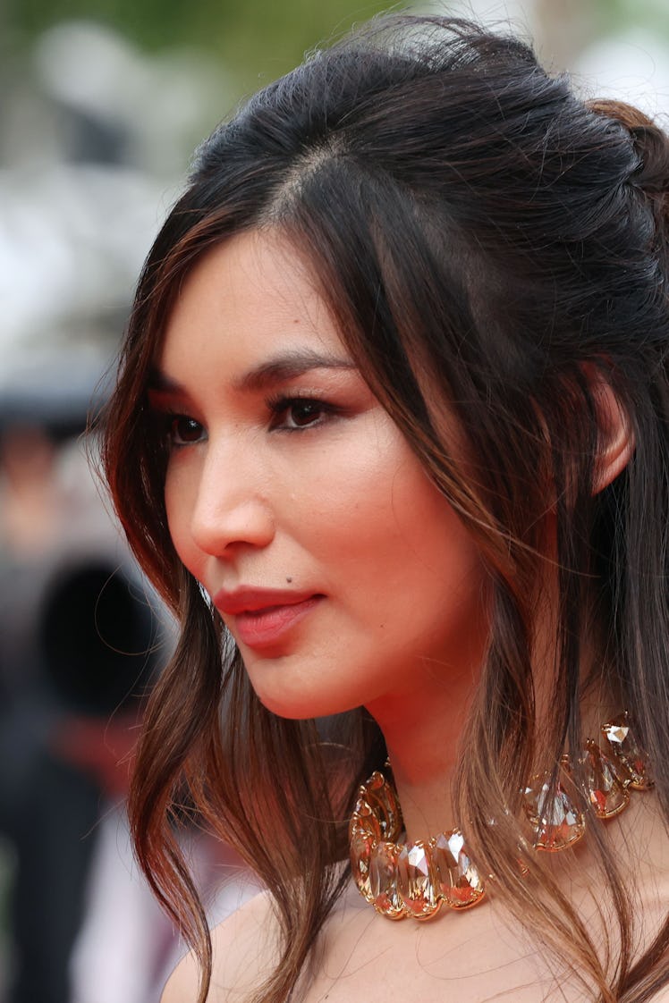 A close-up portrait of Gemma Chan in a large diamond choker necklace at the Cannes Film Festival 202...