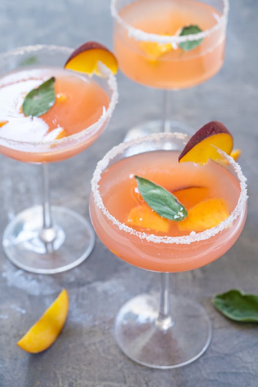 Three peach bellinis at a breakfast table.