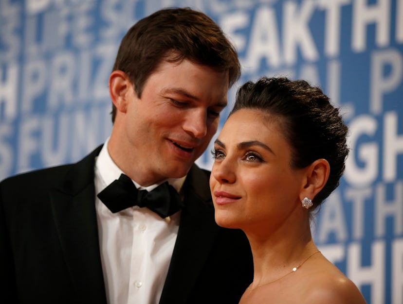 Actor Mila Kunis poses for a picture with her husband actress Ashton Kutcher on the red carpet for t...