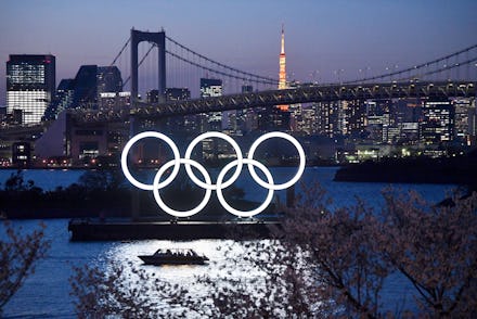 TOKYO, JAPAN - MARCH 25: A boat sails past the Tokyo 2020 Olympic Rings on March 25, 2020 in Tokyo, ...
