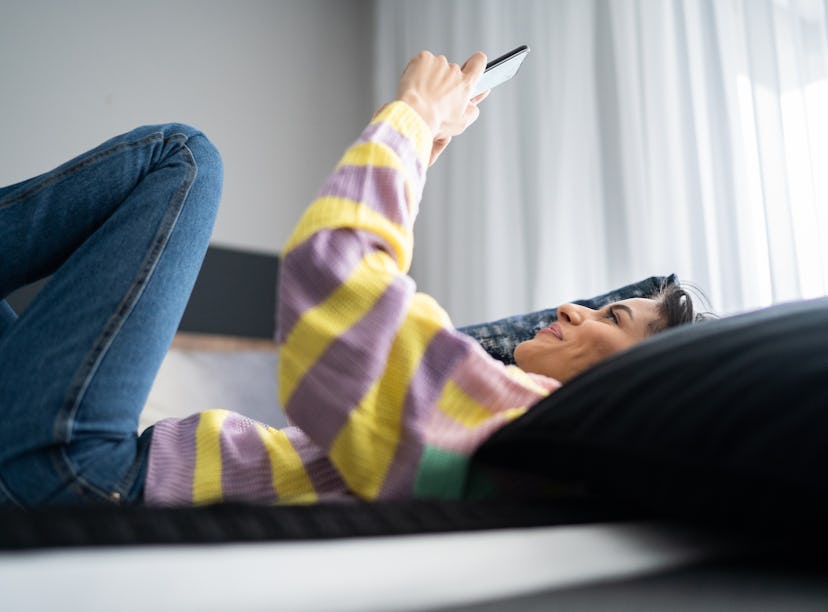 Young woman using smartphone at home