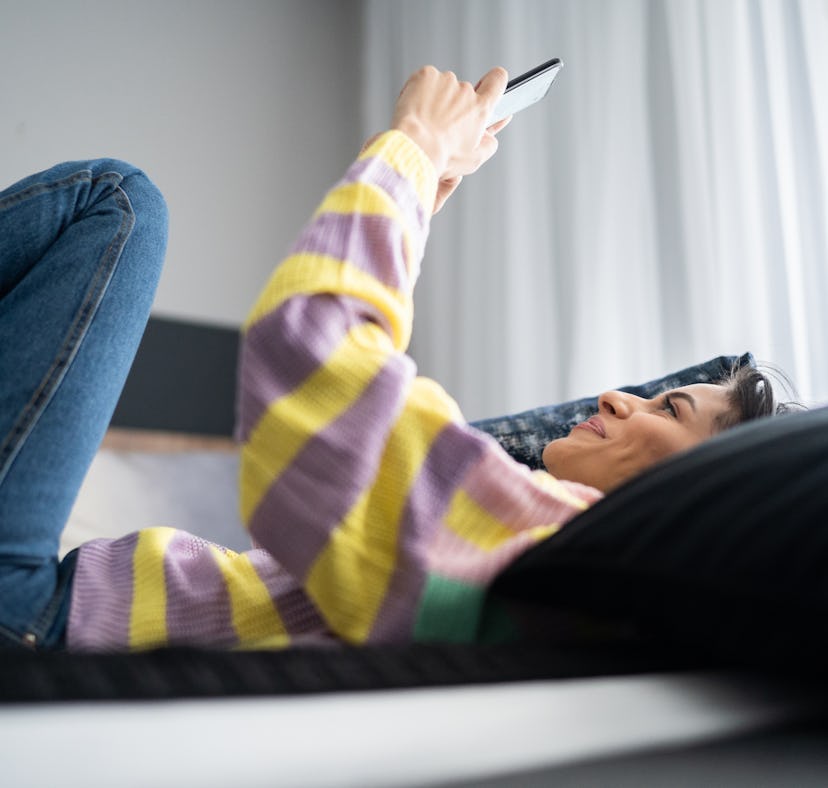Young woman using smartphone at home