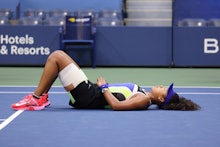 NEW YORK, NEW YORK - SEPTEMBER 12: Naomi Osaka of Japan lays down in celebration after winning her W...
