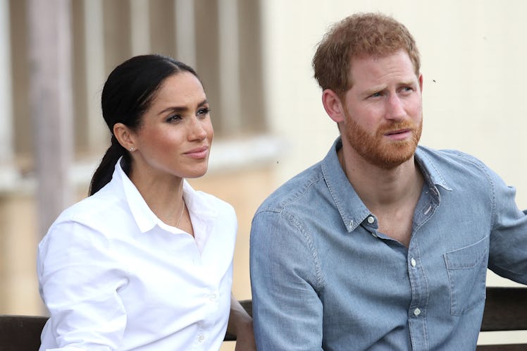 Harry and Meghan are pictured here sitting on a bench, and William and Charles are reportedly "nervo...