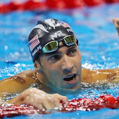 Michael Phelps of the USA celebrates after winning the Gold medal at the Men's 200m Butterfly Final ...