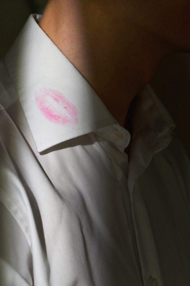 Lipstick marks on the collar of a men's white dress shirt